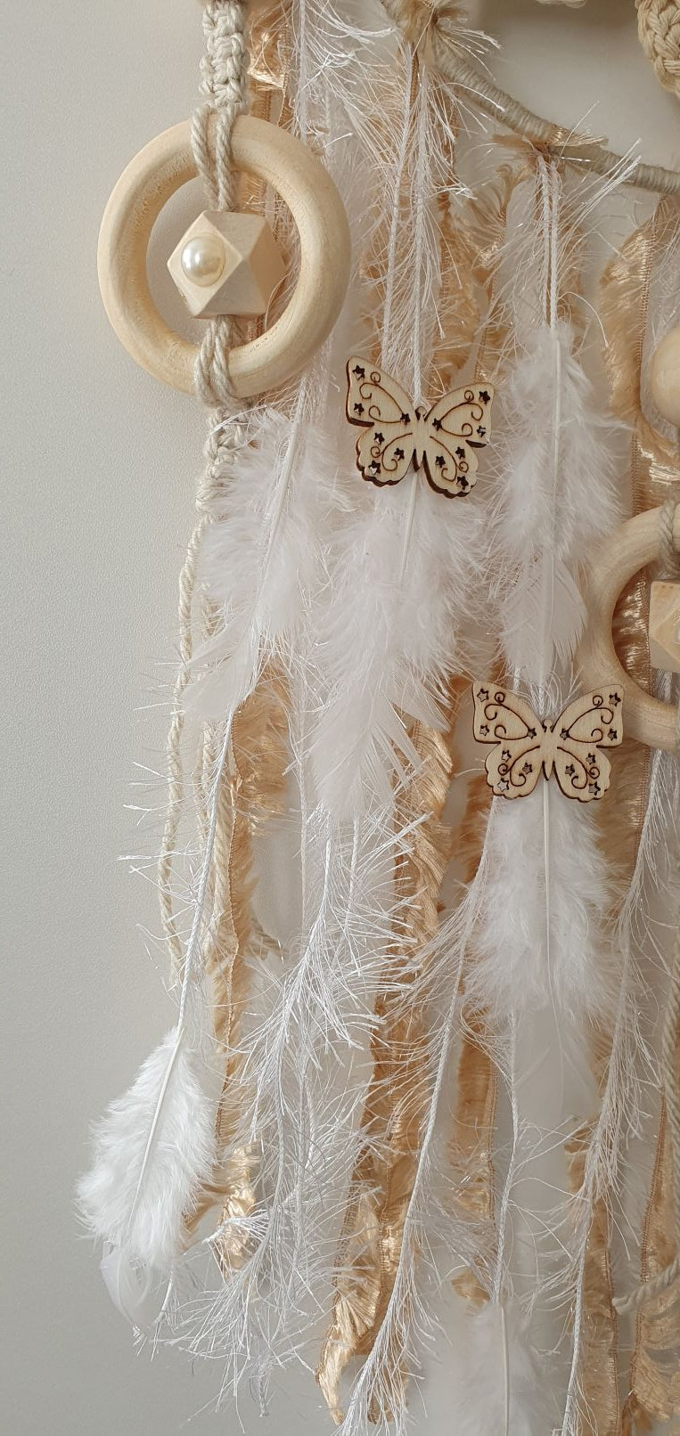 Decorative dreamcatcher with feathers and wooden ring