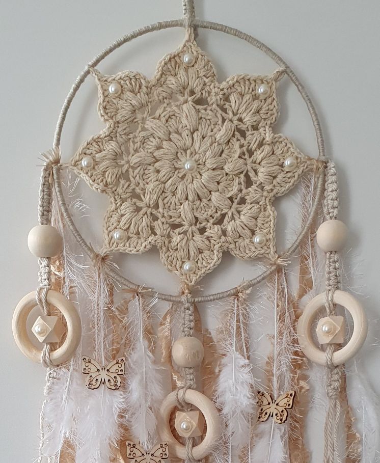 Decorative dreamcatcher with crochet design, feathers, and beads