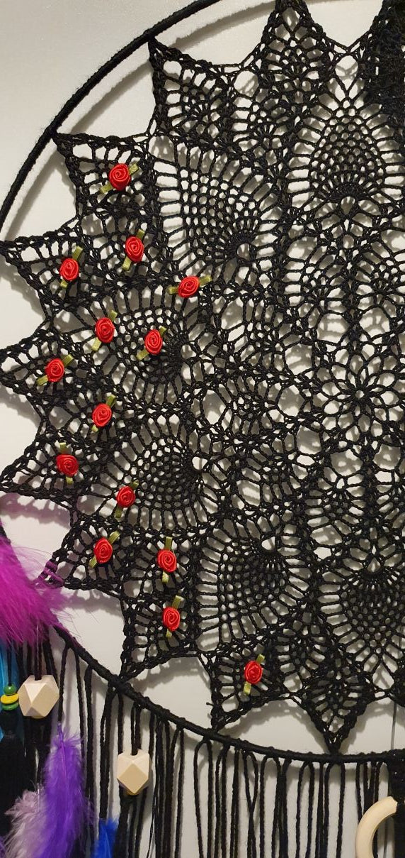 Black lace doily with red small roses