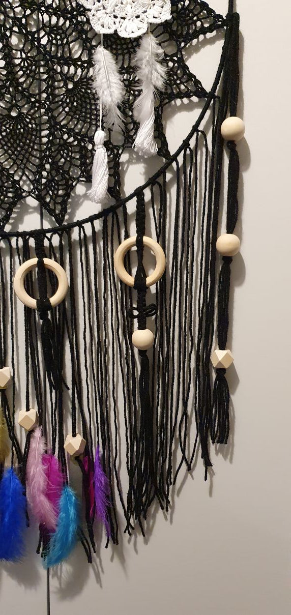 black dreamcatcher decorated with wooden ring and bead