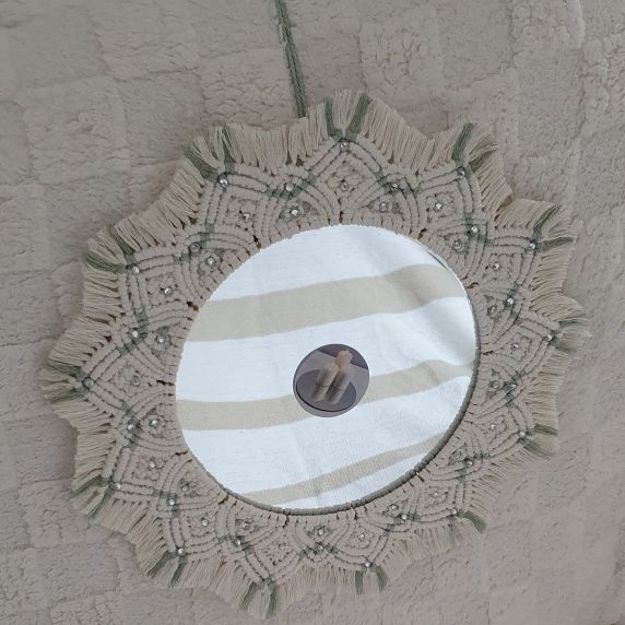 Decorative wall hanging with a circular mirror