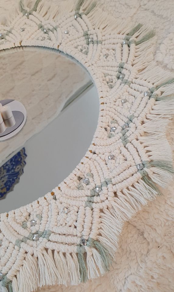 Close-up of a decorative mirror with tassels and beads