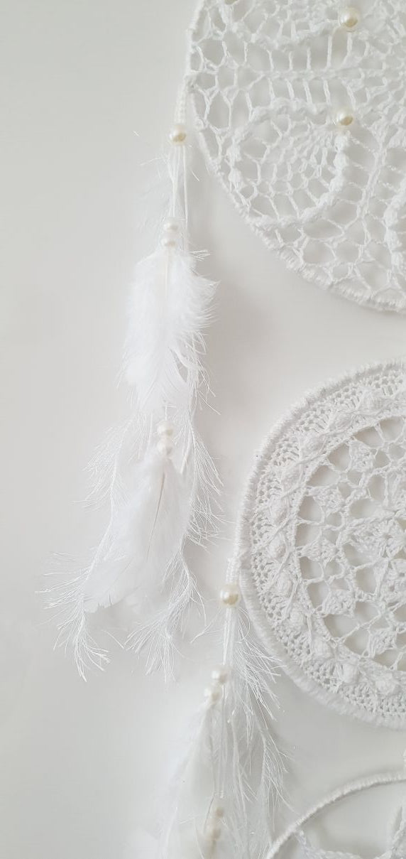 White crochet dream catcher with feathers
