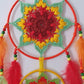 Colorful dreamcatcher with red, yellow, and green patterns 