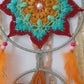 Decorative dreamcatcher with colorful crochet patterns and with feathers