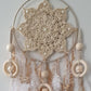Decorative dreamcatcher with crochet design, feathers, and beads 