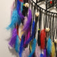 Colorful feathered decorated black dreamcatcher