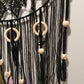 black dreamcatcher decorated with wooden ring and bead