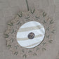 Decorative wall hanging with a circular mirror