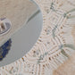 Close-up of a decorative mirror with tassels and beads 