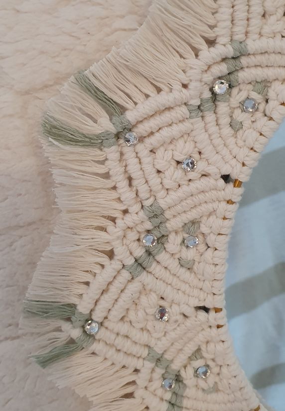 Close-up of a macrame wall hanging with tassels and beads 