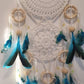 white dream catcher with turquoise feather