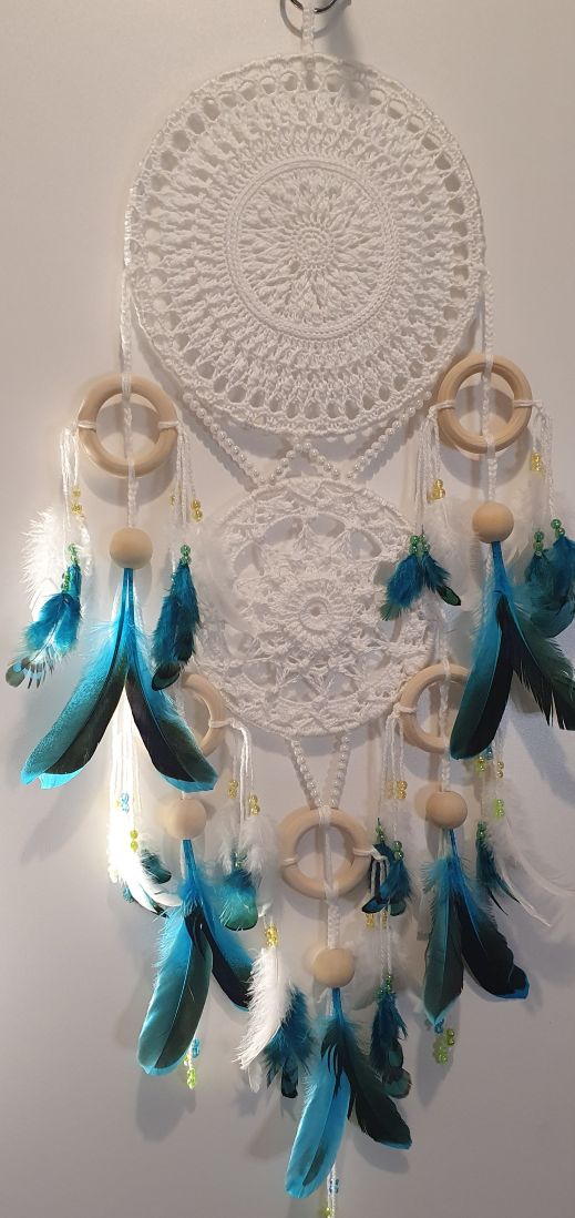 white dream catcher with turquoise feather