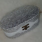Elegant clutch bag with crystal embellishments on a neutral background