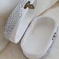 White jewelry box with silver embellishments on a light background