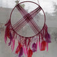 round pink macrame dreamcatcher with pink feather