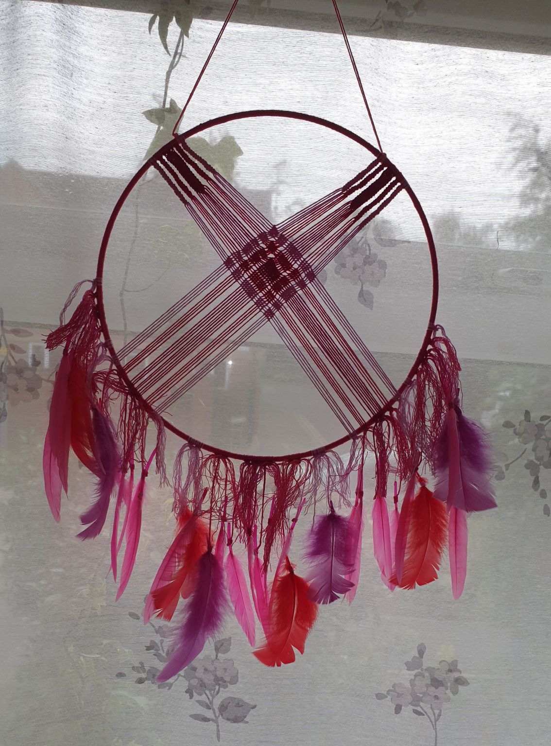 round pink macrame dreamcatcher with pink feather