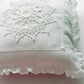 white small cushion with crochet lace