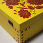 yellow wooden box with red flowers
